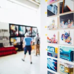 How to Make Money Selling AI-Generated Art on Etsy in 2026 (Beginner's Guide) Colorful artwork showcased in a modern gallery setting with people browsing.